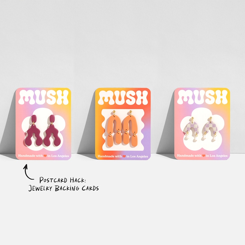 3 similarly designed postcards being used as jewelry backing cards.