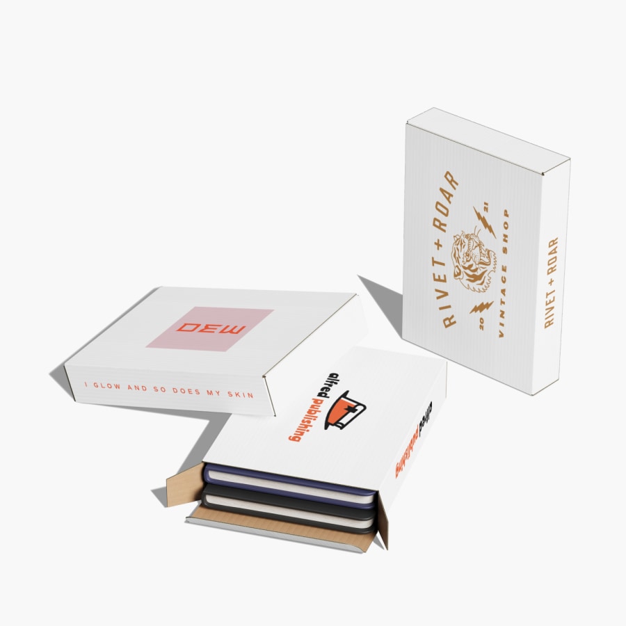 3 logo flat shipping boxes – 1 is filled with notebooks.