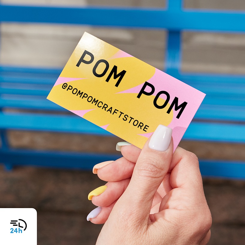 A person holding a business card from a craft store, with a 24-hour delivery icon in the corner.