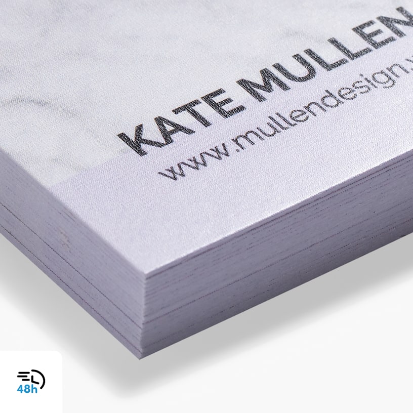 A close-up of a stack of white matte business cards, with a 48-hour delivery icon in the corner.