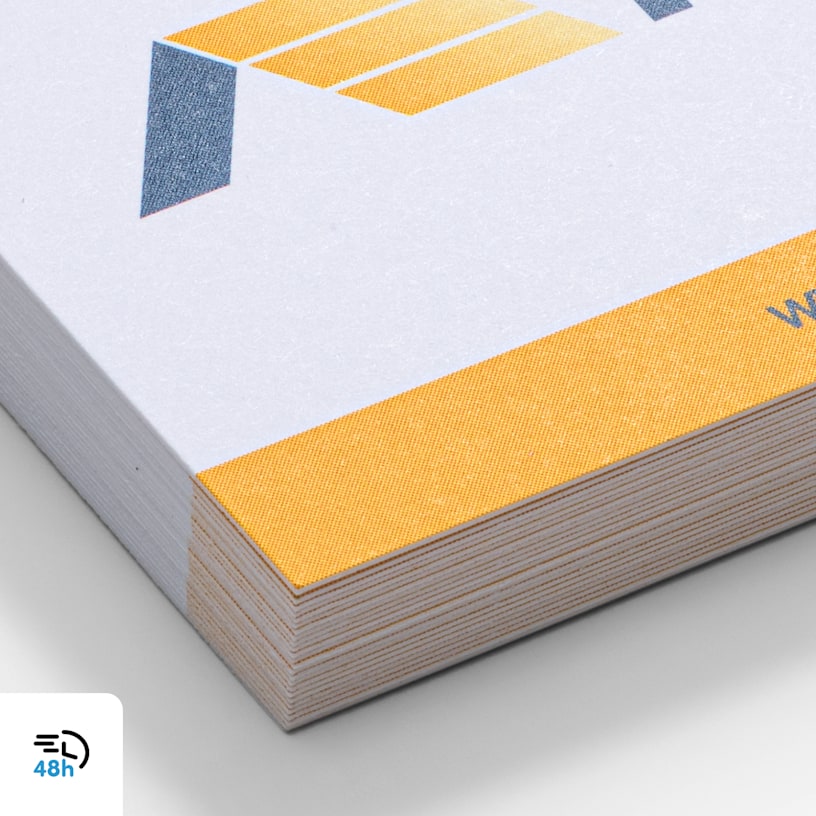 A close-up of uncoated white and yellow business cards, with a 48-hour delivery icon in the corner.