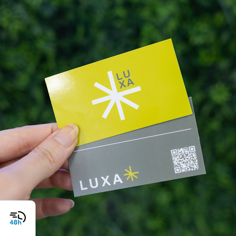 A hand holding yellow and gray business cards for a health supplements brand, displayed against green foliage, with a 48-hour delivery icon in the corner.