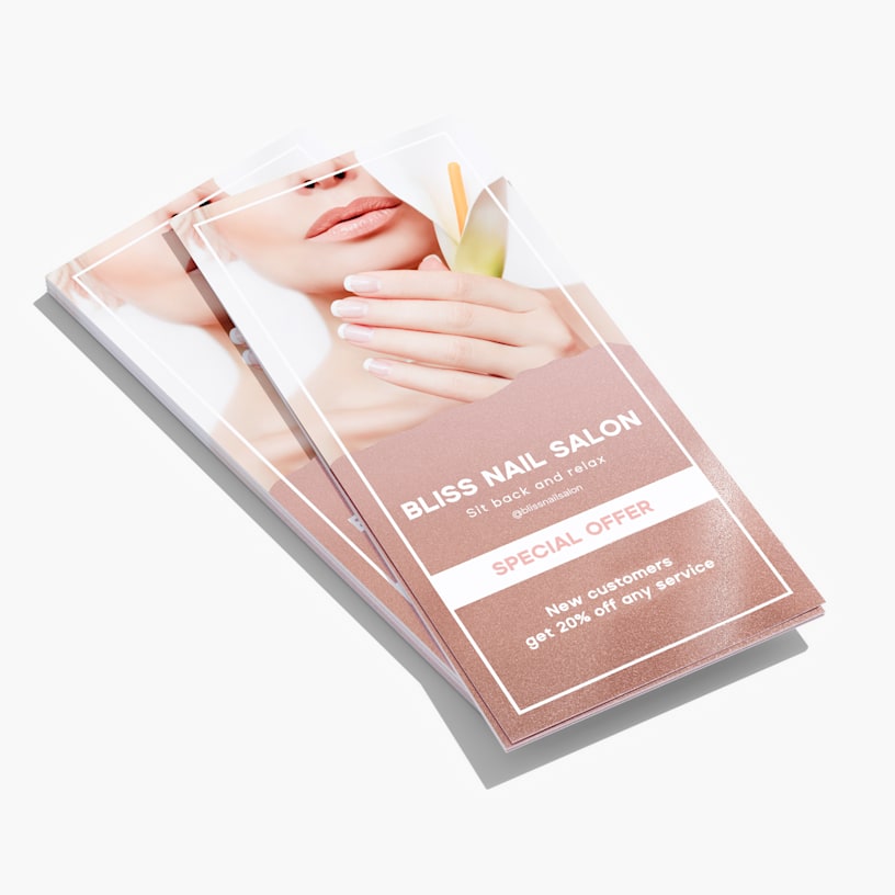 A stack of accent rack cards from a nail salon with glossy bronze highlights.