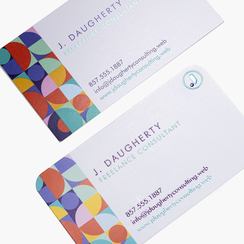 A detailed view of business cards stacked at an angle, showing rounded corners and traditional matte cards.