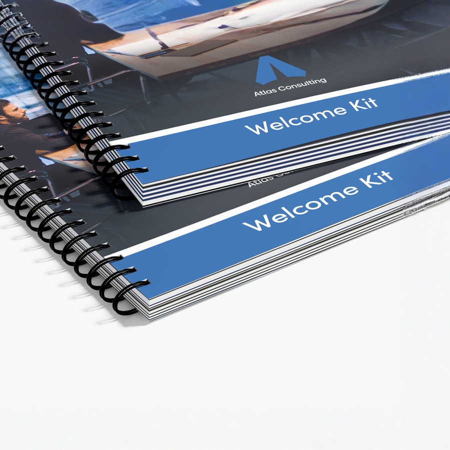 A stack of wire-bound reports and consulting materials for business services.