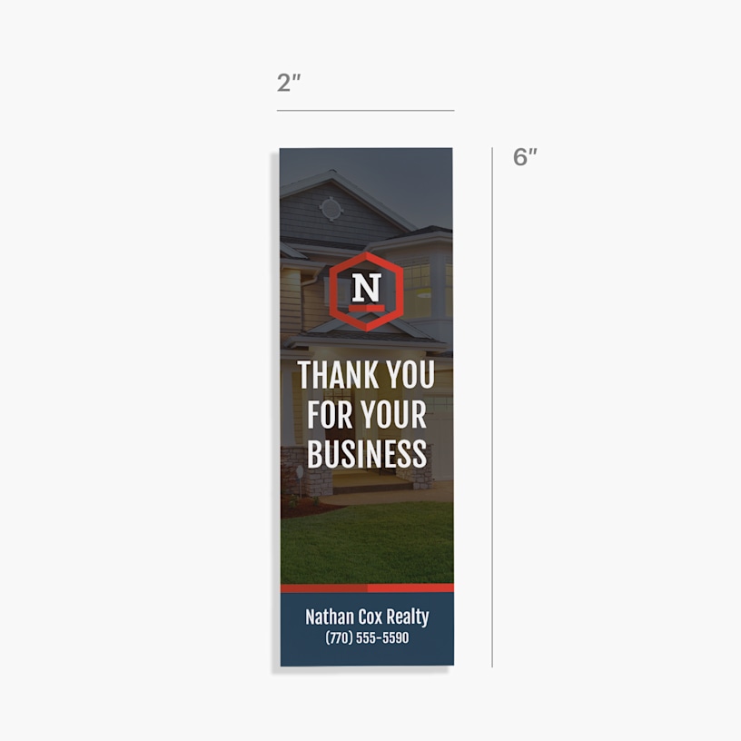 A bookmark customized for a realty business with dimensions indicating it is 2 inches wide and 6 inches tall. 