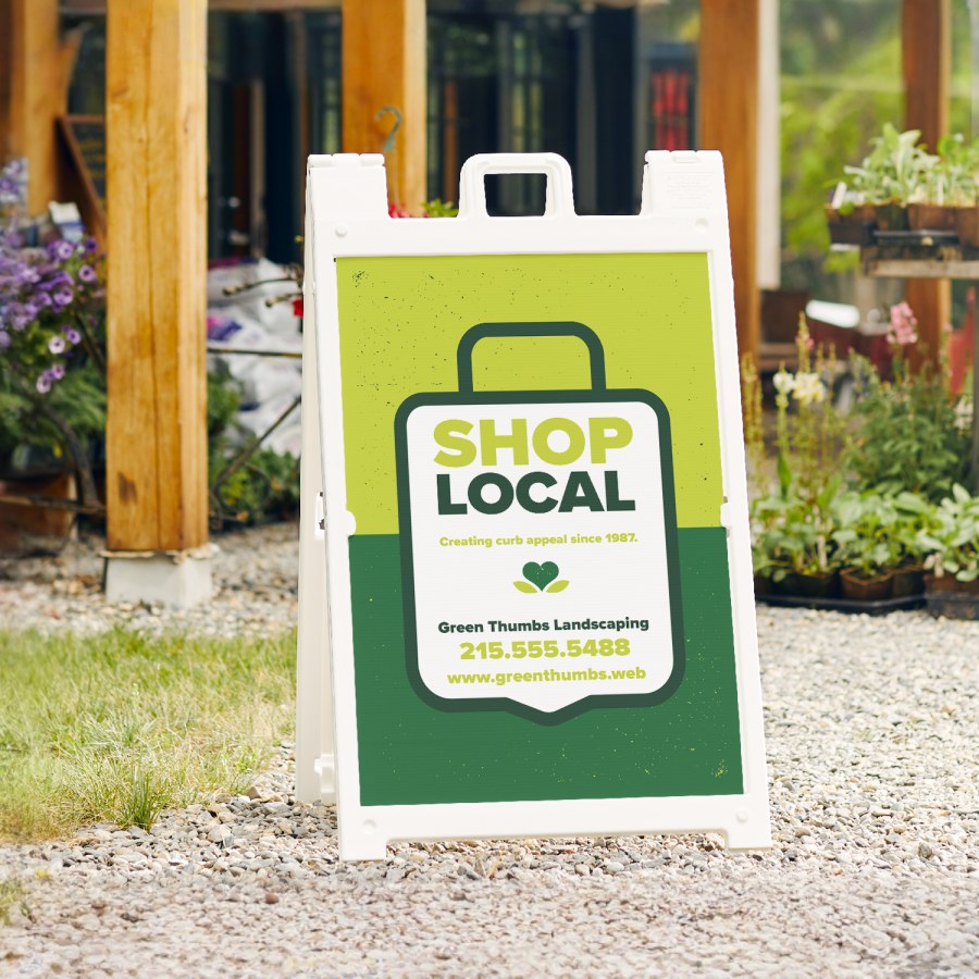  A white Signicade® featuring a landscaping company.