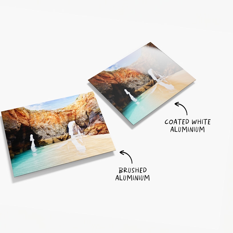 Two aluminium prints, both featuring landscape photos. There is text that reads that there are two material options, one being brushed aluminium and the other coated white aluminium.