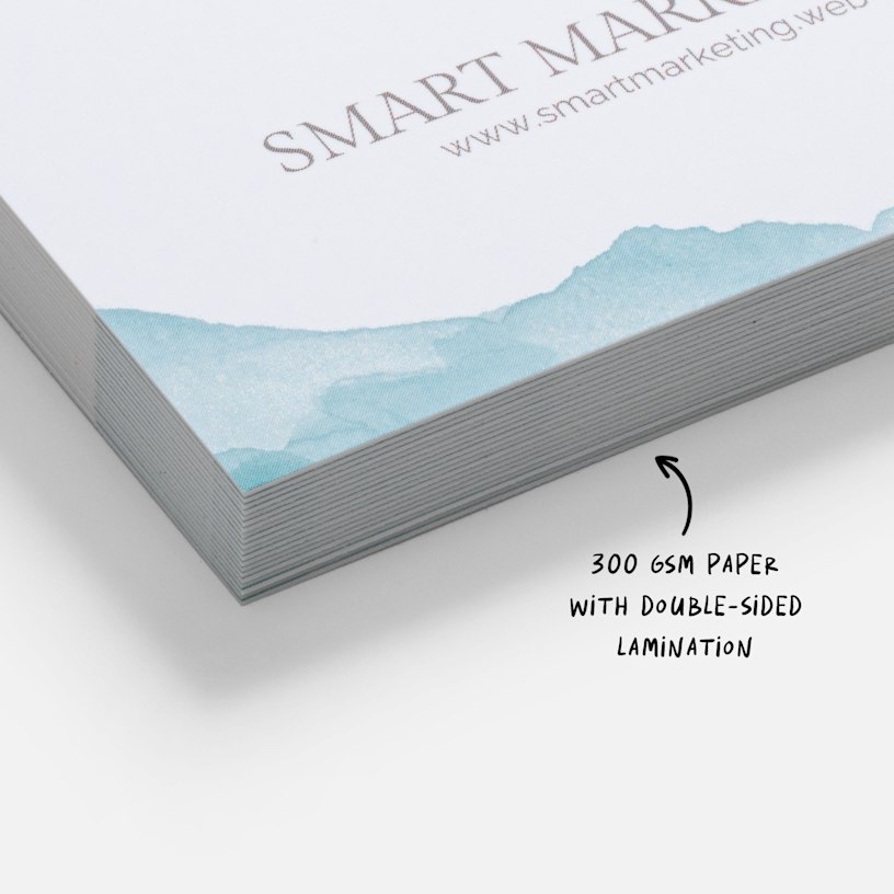 A close-up view of a stack of soft touch business cards, with a note that highlights the 300 gsm paper thickness and the double-sided lamination.