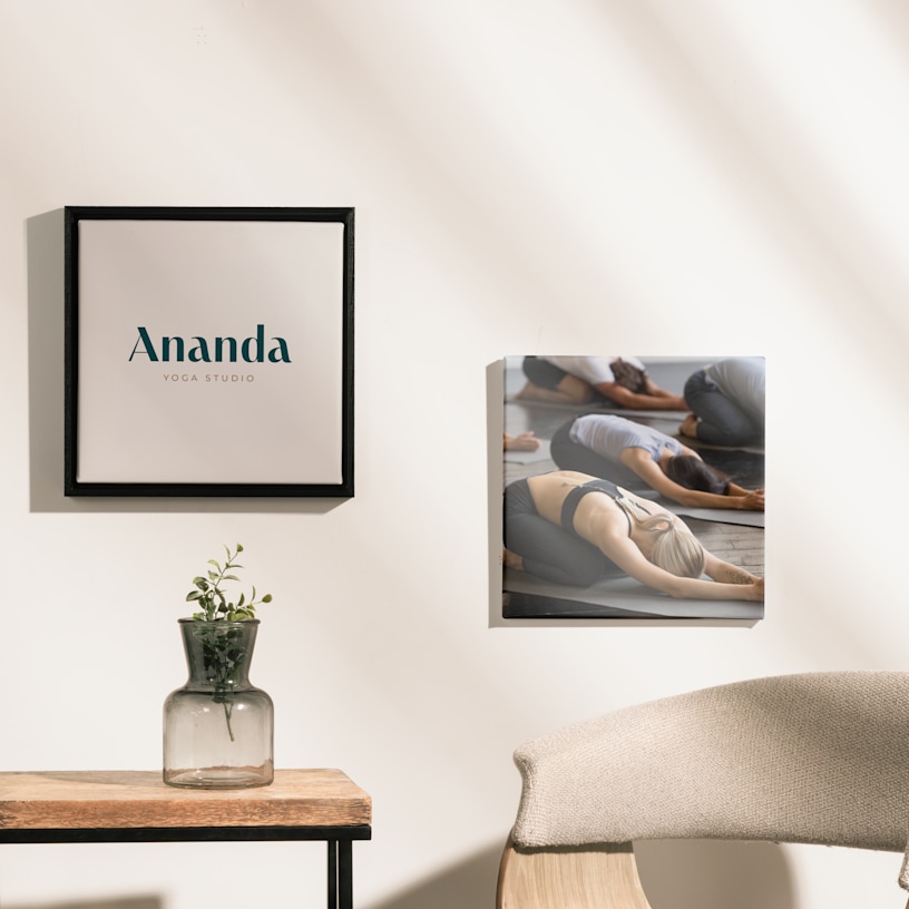Two canvas prints (one framed and one frameless) for a yoga studio. One is printed with the name of the yoga studio and the other features a group class in child’s pose.