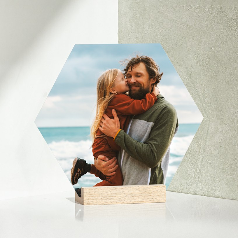 A hexagon-shaped tabletop print featuring a father and his daughter. 