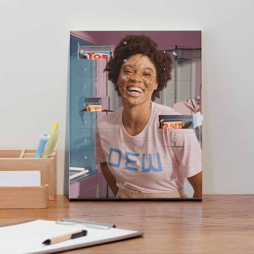 A custom advent calendar resting against the wall on a desk, featuring branding for a business called Dew. 