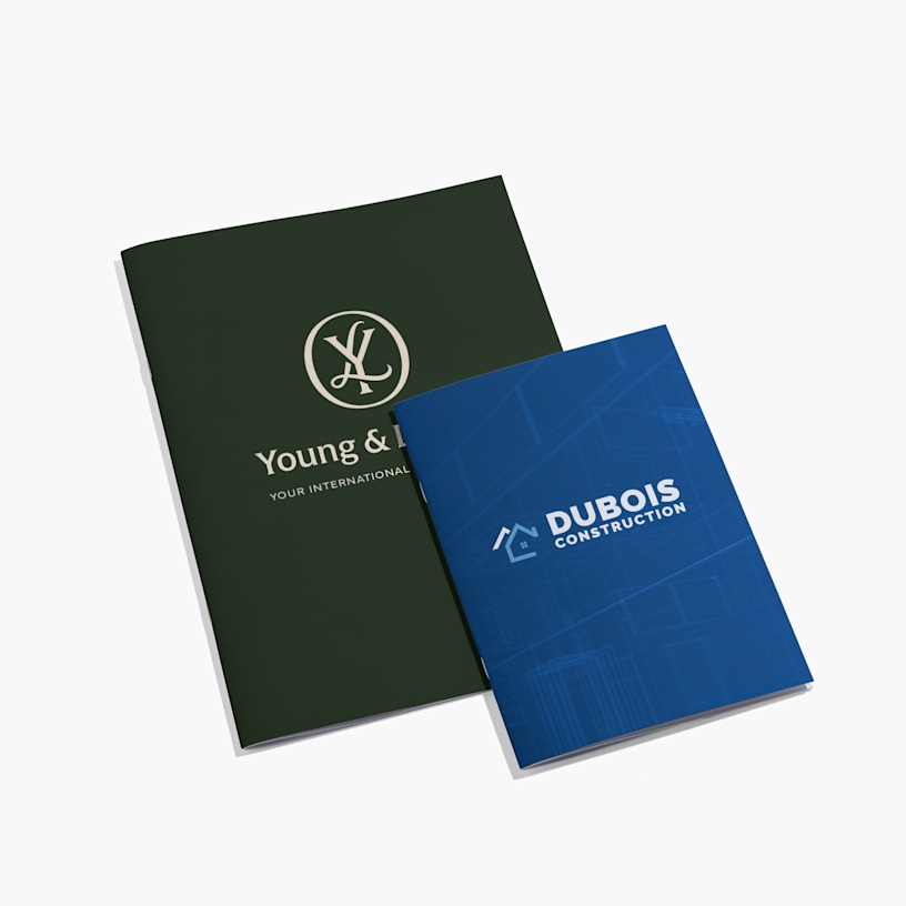 Two custom notebooks with corporate branding - green Young & Lefranc notebook and blue Dubois Construction notebook.