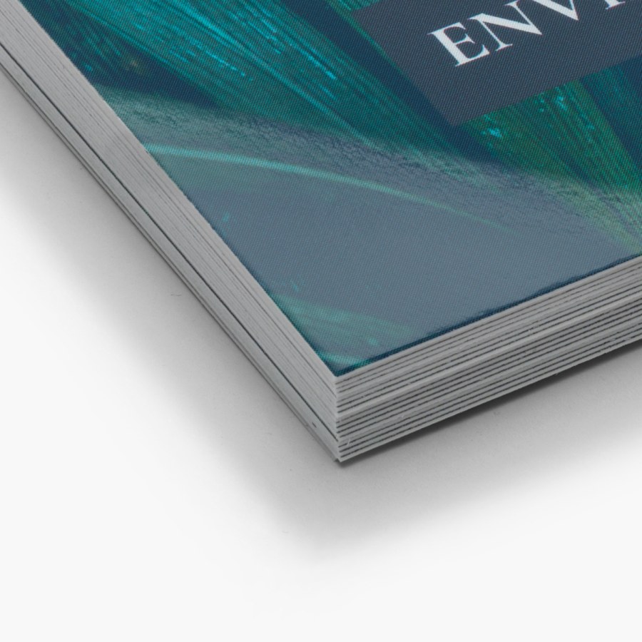 A stack of glossy business cards, featuring sharp, square corners, is shown in a close-up view.