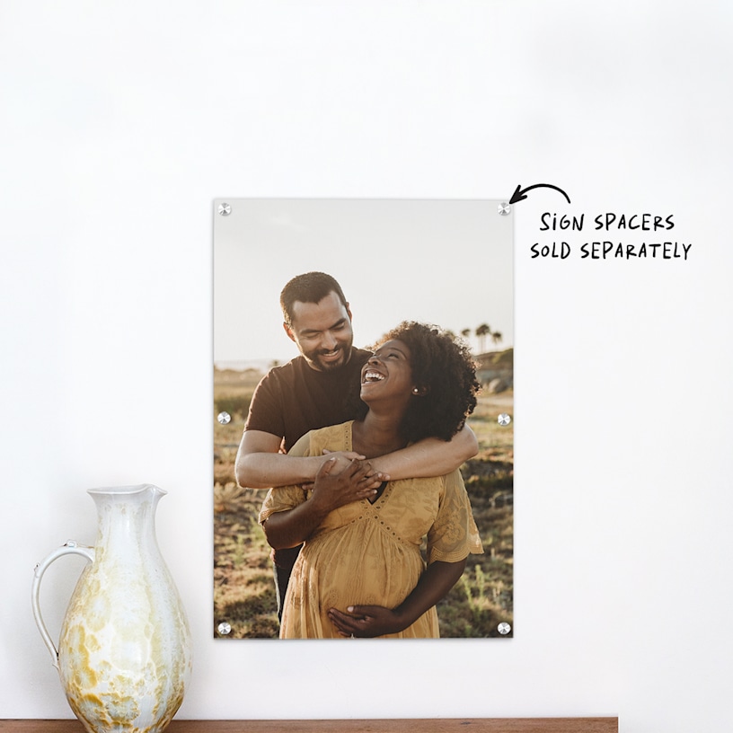 An acrylic print featuring a young couple’s maternity photo. 