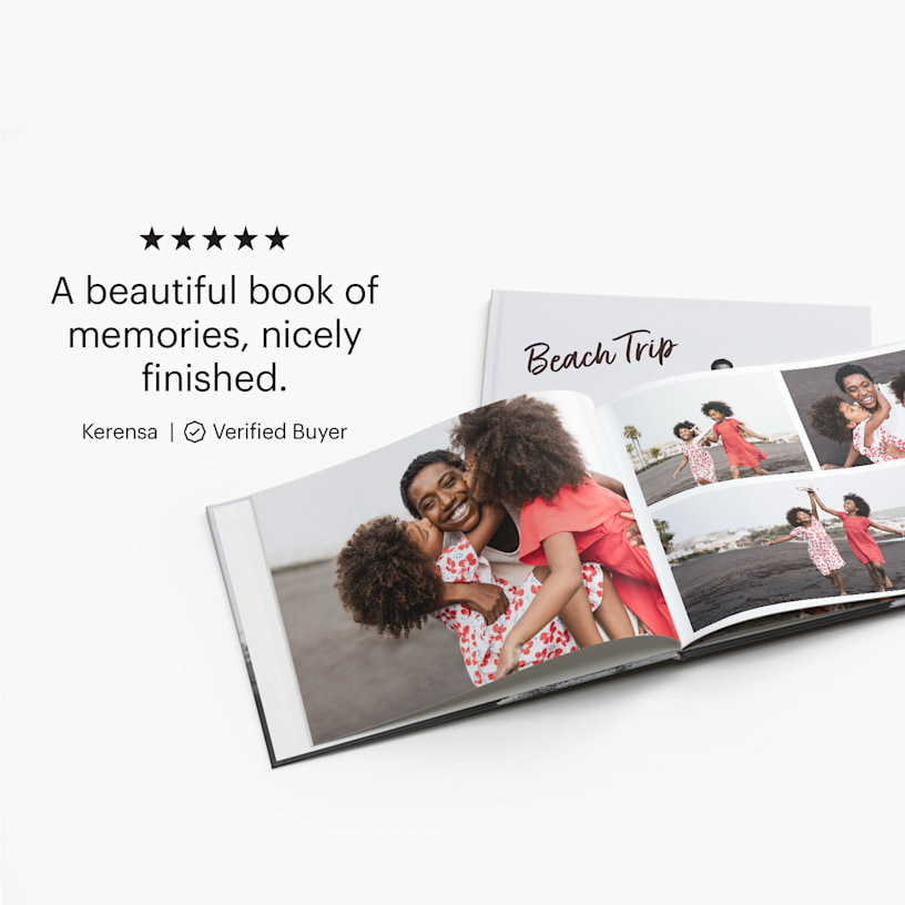 An open photo book featuring a collage of family photos from a beach trip. A customer review for photo books reads: "A beautiful book of memories, nicely finished".