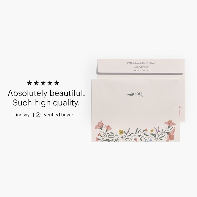 The front and back of a floral envelope printed with both a recipient and return address, with a custom review: “Absolutely beautiful. Such high quality.” 