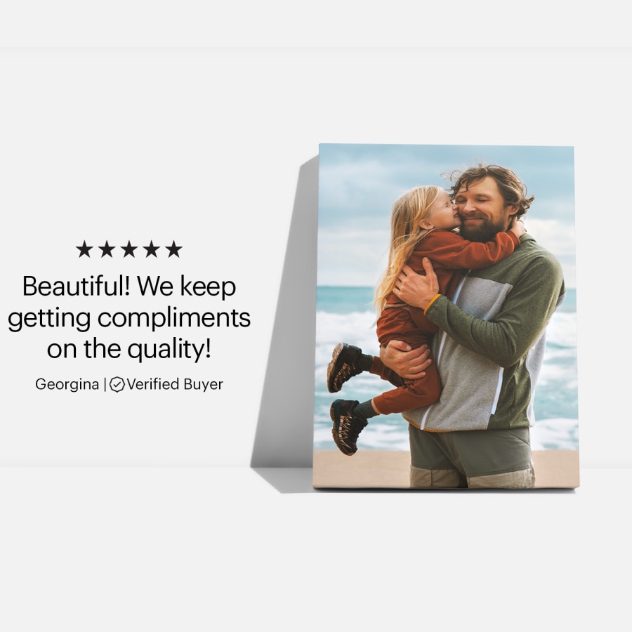 A canvas print featuring a photo of a father and his daughter at the beach, and a customer review: “Beautiful! We keep getting compliments on the quality!”