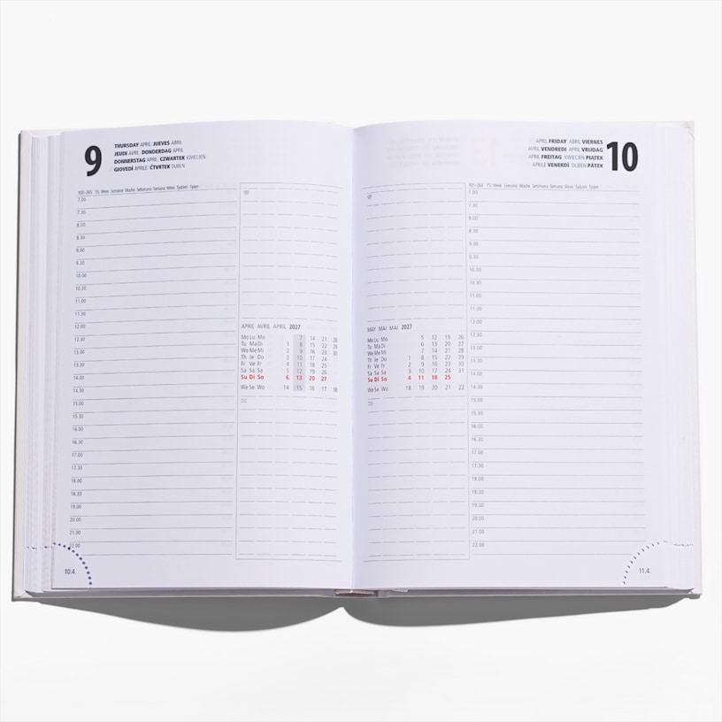 An open hardcover diary with a note showing the bookmark and another callout about the corner perforation.