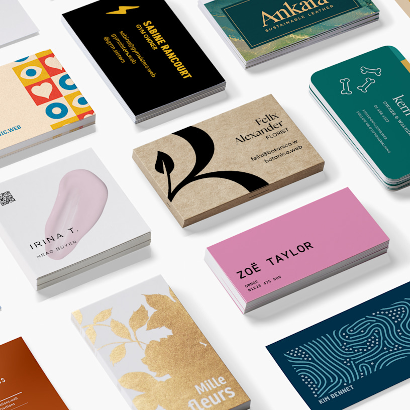 A vibrant collection of standard business card designs is arranged neatly on a white surface.