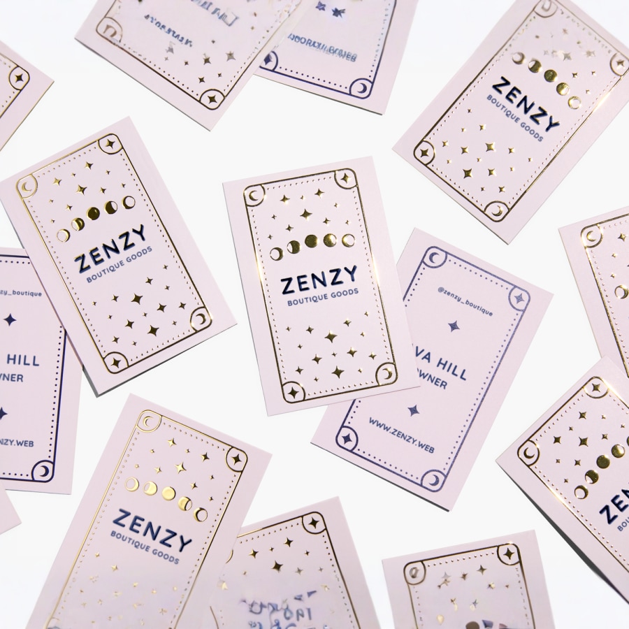 A raised foil business card promoting a boutique shop..