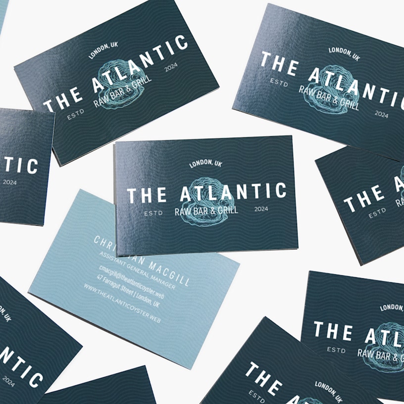 Front and back views of glossy business cards, designed for a restaurant.