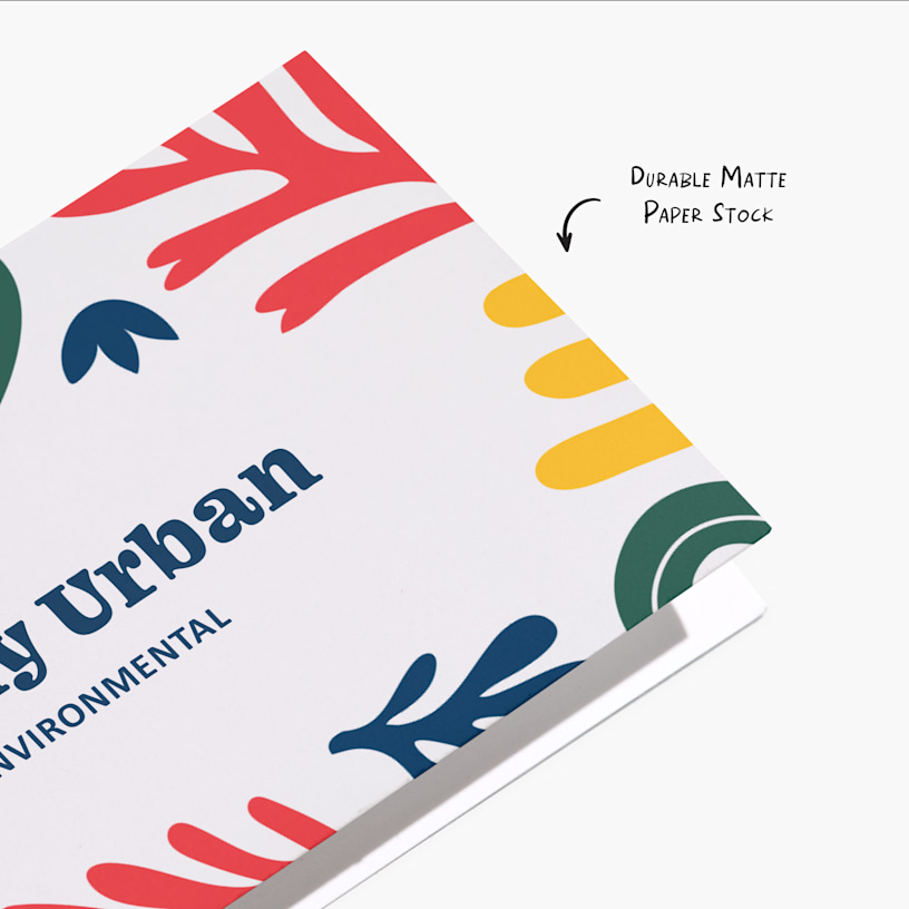 A close-up shot of a folded business card with a note pointing out its durable matte paper stock.