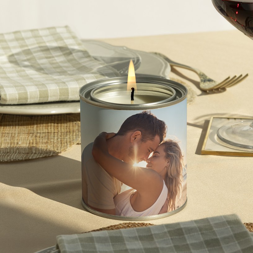 A custom candle printed with a photo of a couple embracing. 