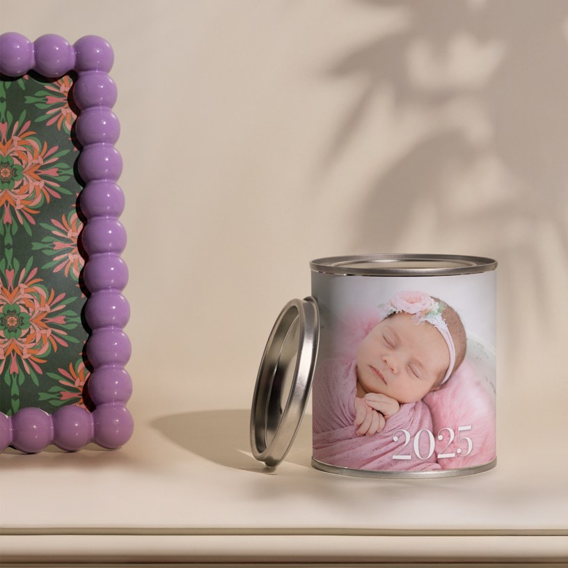 A personalised photo candle customised with a picture of a baby girl and the year, ‘2025’. 