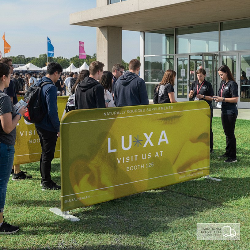 An event barrier promoting a wellness business, featuring a logo and a booth number.  