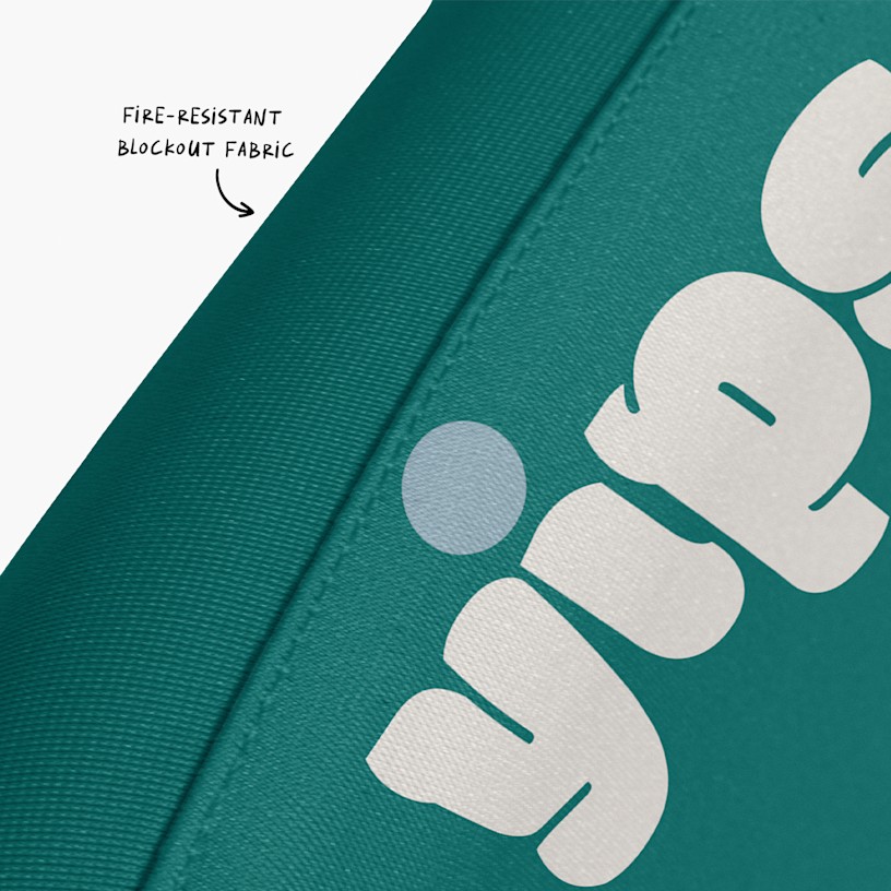 A closeup of the event barrier fabric, with an arrow pointing to its fire-resistant, light-blocking feature.