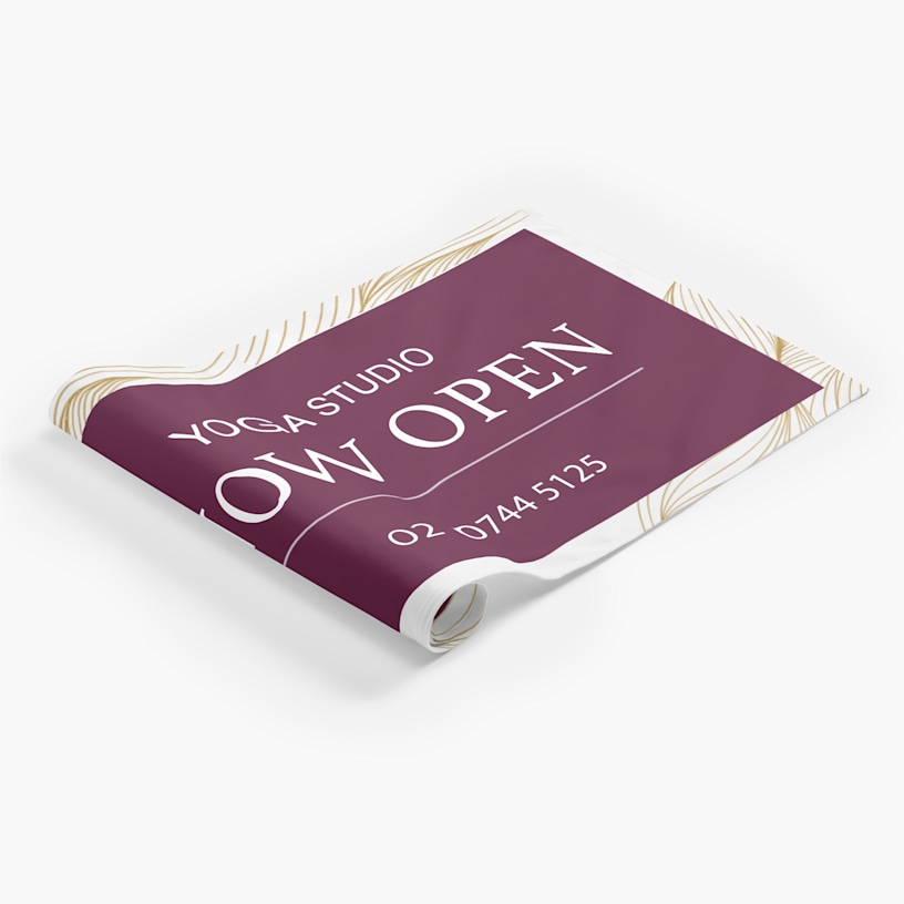 A fabric poster promoting a yoga studio, partially unrolled.