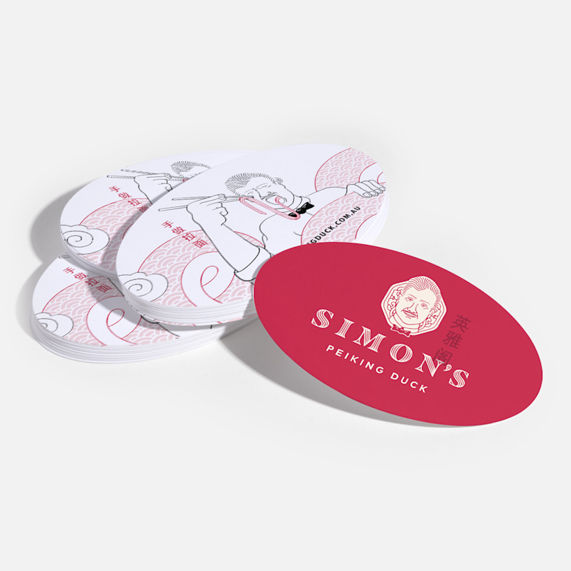 Oval business cards promoting a restaurant, with an illustration at the back.