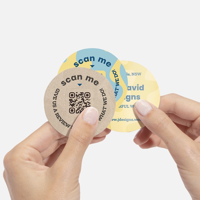 Circle name cards with review QR codes promoting a designer's services. 