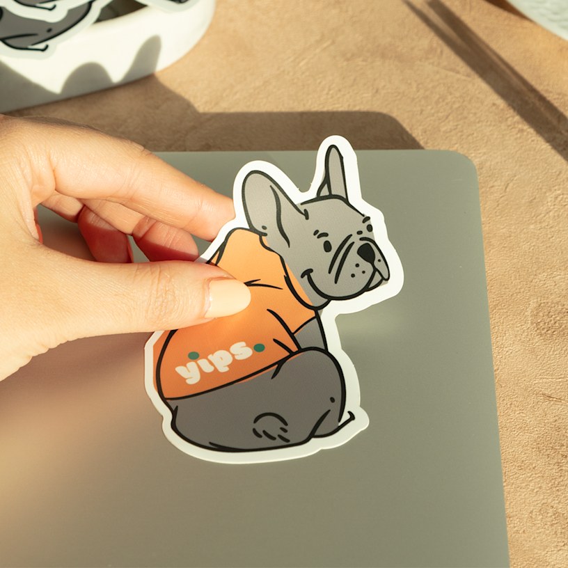 A custom die-cut sticker shaped like a dog, promoting a dog walking business.