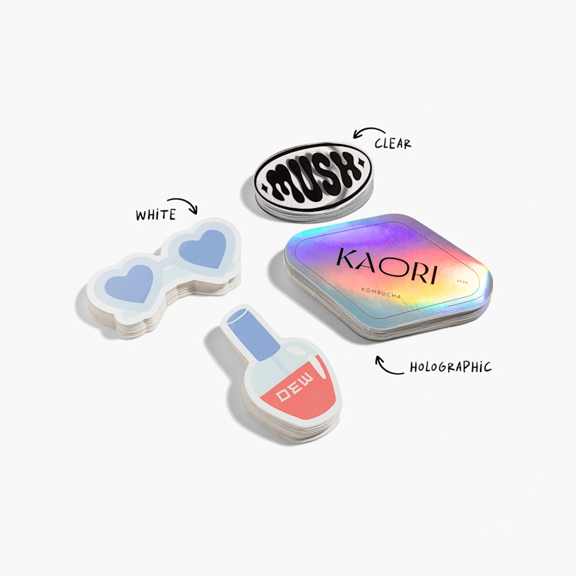 Three different die-cut sticker materials, side by side: white, clear and holographic.