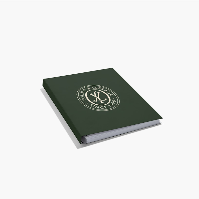 A custom wraparound spiral notebook with a consultancy firm's logo at the centre of the cover.