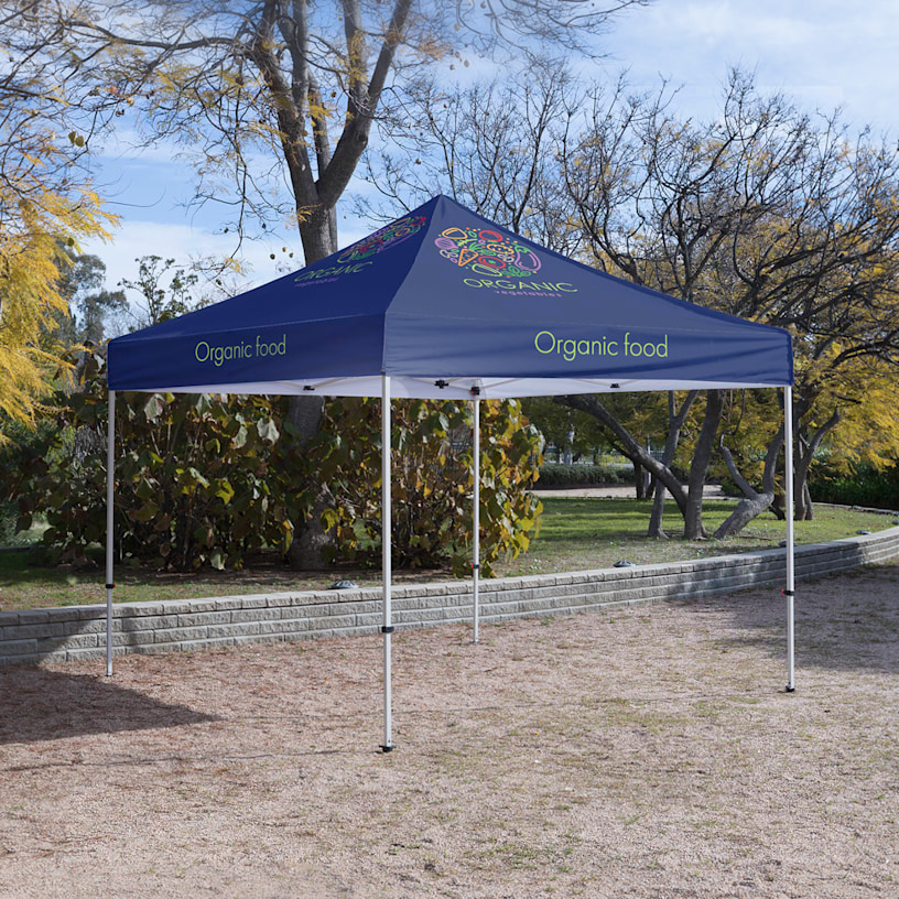 An organic food canopy tent set up in an outdoor setting.