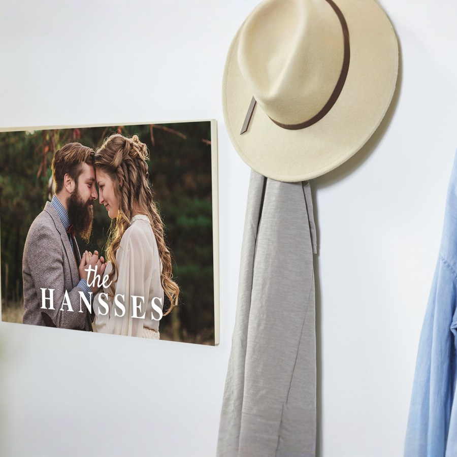 A photo wood print displayed on a wall printed with a couple’s wedding picture.