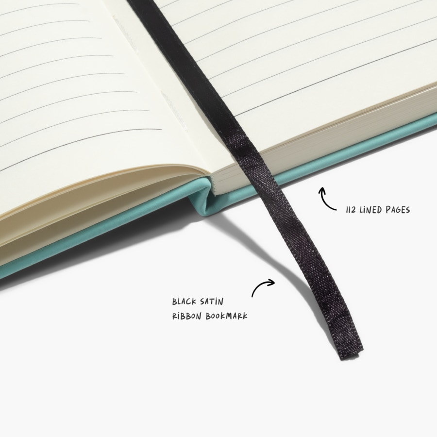 A close up shot that highlights the lined paper, and ribbon page marker.