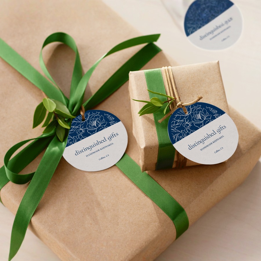 2 hang tags tied onto wrapped gifts with string.