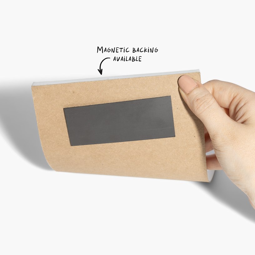 The magnetic backing on a custom notepad, with a note pointing out the magnetic backing.