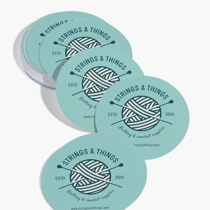 A stack of circle business cards for a knitting and crochet supply store.