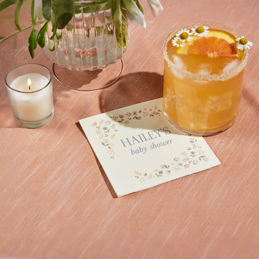 A cocktail napkin personalized for a baby shower. 