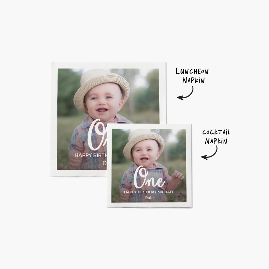 Two napkins featuring a photo of a one-year-old boy and a birthday message, with notes that one is a luncheon size and the other is a cocktail size. 