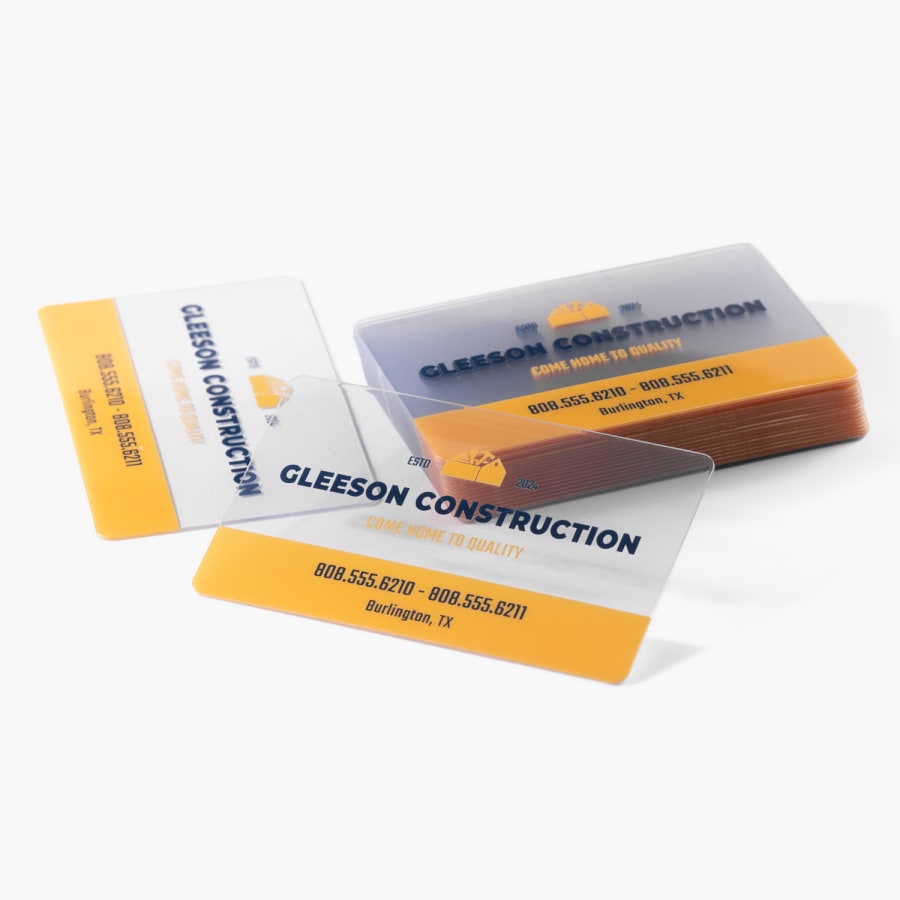 A stack of clear plastic business cards for a construction business.