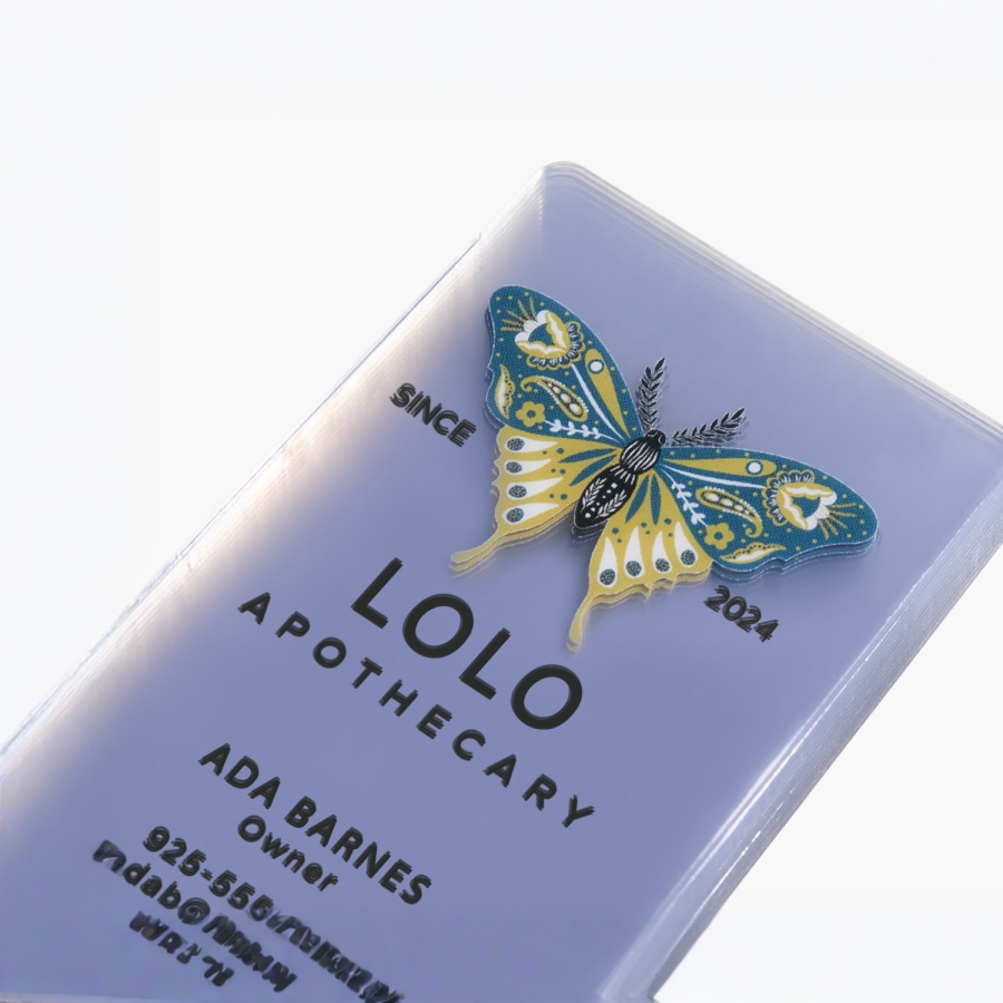 A stack of clear plastic business cards for a holistic health store owner.