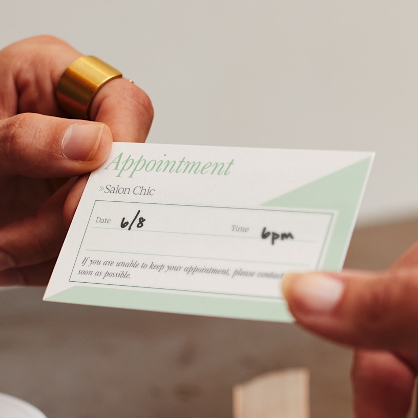 An appointment reminder card for a salon, with a note that it’s easy to write on.