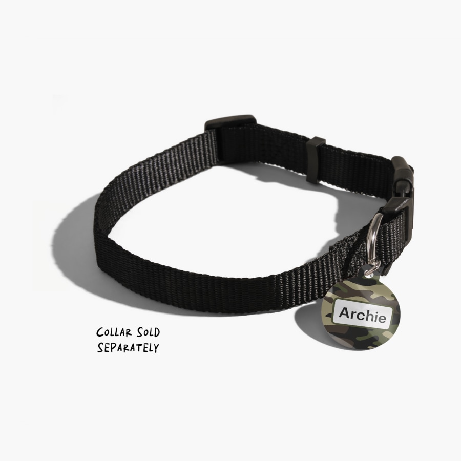 A custom pet tag with a camouflage design, attached to a black dog collar.