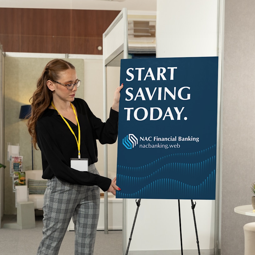 A woman standing next to a foam board displayed on an easel.